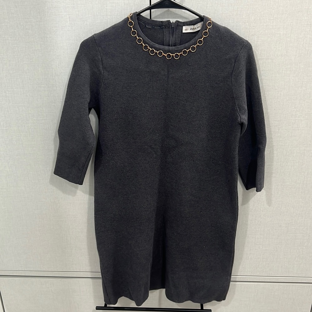 ZARA: grey sweater dress with golden ring necklace attached to the dress